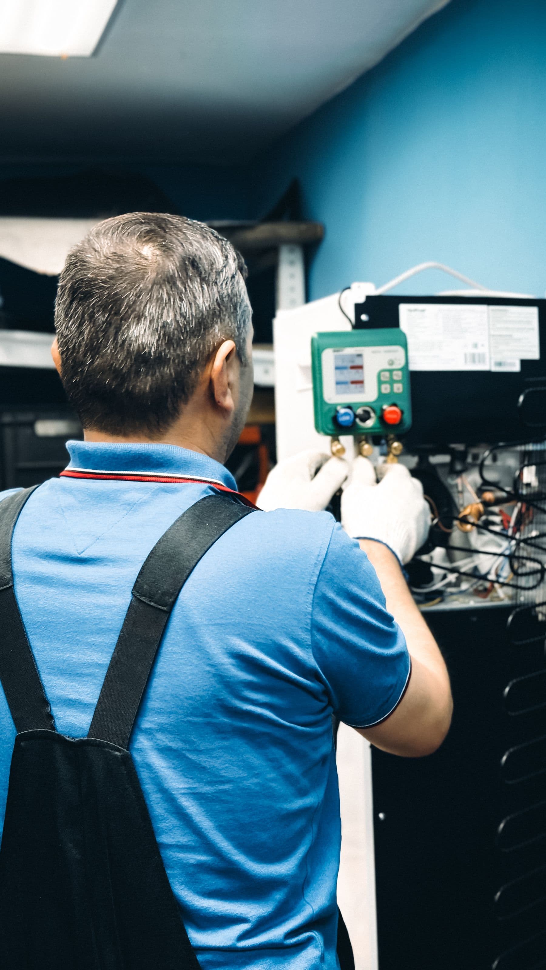 Technician servicing equipment from behind